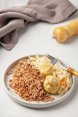 Meatballs with buckwheat porridge and cabbage salad. Baby or diet nutrition