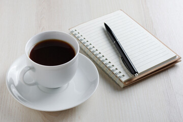 Coffee and notepad with pen