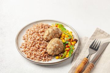 Meatballs with buckwheat porridge and vegetable salad. Baby or diet nutrition.