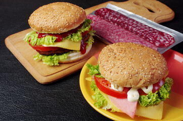 Harmful food. Fast food. Fried meat burgers, mayonnaise, ketchup and sauces.