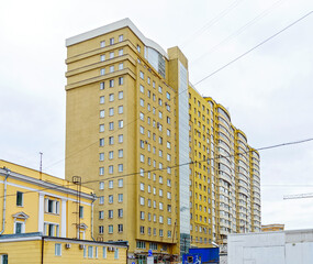 New building of a multi-storey residential building. multi-storey residential building in brown and beige tones.