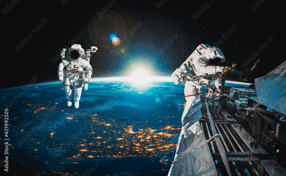 Wall mural astronaut spaceman do spacewalk while working for space station in outer space . astronaut wear full