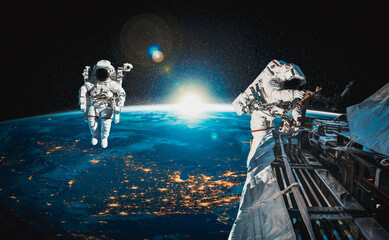 Astronaut spaceman do spacewalk while working for space station in outer space . Astronaut wear...