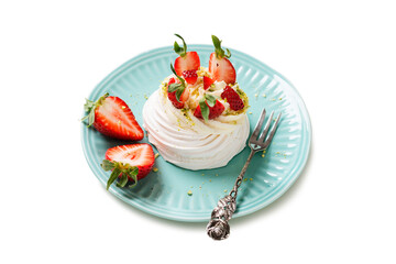 Perfect mini Pavlova cake with whipped mascarpone cream and fresh strawberry slices, sprinkled with crushed pistachios. isolated on white background