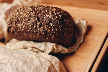 loaf of bread flour product wooden board tray and paper packaging