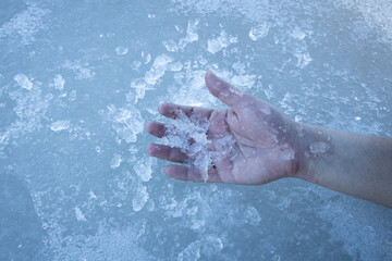 A hand on the ice surface. Died from the cold. The concept of a dangerous accident or heater failure in the cold season.