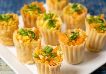 Close up view of Malaysian Peranakan Chinese thin and crispy pastry tart shell appetizer dish or locally known as "Pai Tee" with dipping sauce. Selective focus.