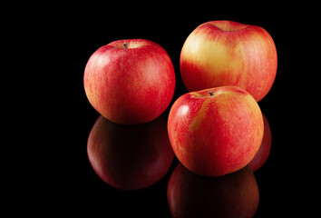 Three ripe red apples