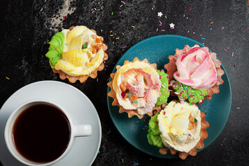 Cakes, tartlets with cream in a plate