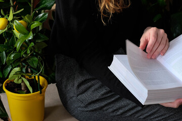 Woman reading a book, girl holds white book while reading at home. Reading mock up , close up details. 