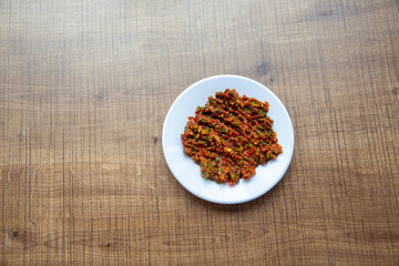 top view, turkish food spicy paste in round white plate. appetizer.