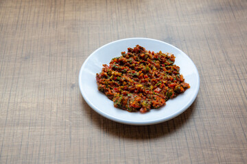 top view, turkish food spicy paste in round white plate. appetizer.