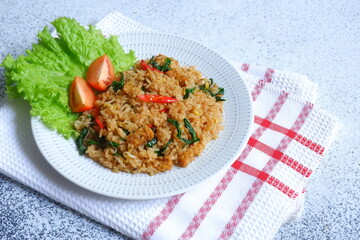 a plate of fried rice served with vegetables 