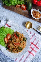 a plate of fried rice served with vegetables 