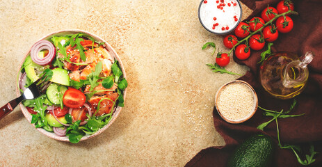 Fresh salad with grilled chicken, cherry tomatoes, arugula, red onion, avocado, sesame seeds and lemon oil dressing. Healthy food concept. Top view. Copy space