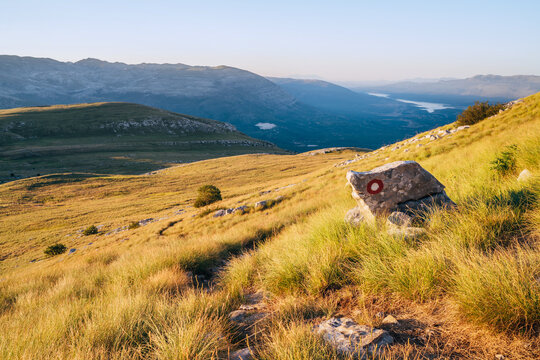 Hiking trail mark painted on rock. Landscape view from Sinjal or Dinara (1831 m) mountain -the highest point of Croatia in the Dinaric Alps on the border between the Croatia and Bosnia and Herzegovina