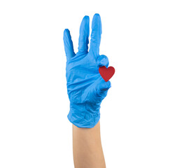 hand in blue medicine glove holding wooden red heart with two fingers showing it isolated on white background