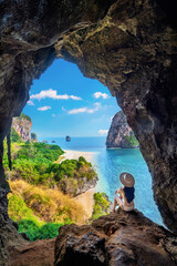 Woman sitting in the cave at Railay, Krabi, Thailand.