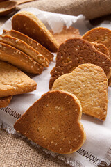Fototapeta na wymiar Homemade crispy cookies with sesame seeds in the shape of heart