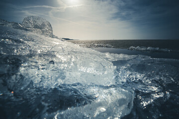 Frozen icicles of brash ice in winterlandscape. Transparent shining clear ice