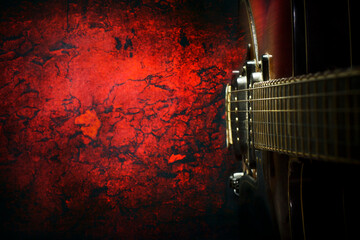 Old, jazz electric guitar on a red grunge background. Copy space. Top view Background for music festivals, concerts. Musical education. Concert concept.