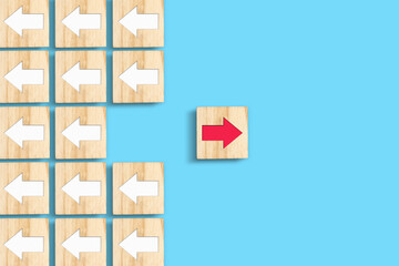 Wooden blocks with white and red arrows. Different directions. Leadership success concept....