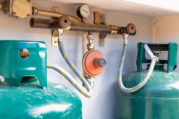 Close up on two gas cylinders connected to the LPG regulator and to the residual gas detector....