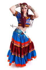 Beautiful young female belly dancer with red a blue dress and sword