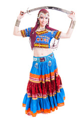 Beautiful young female belly dancer with red a blue dress and sword