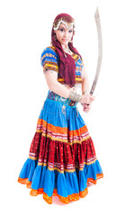 Beautiful young female belly dancer with red a blue dress and sword