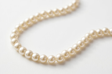 Pearl necklace on white background, close-up