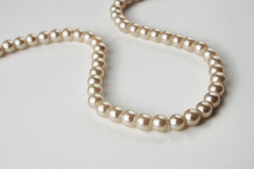 Pearl necklace on white background, close-up
