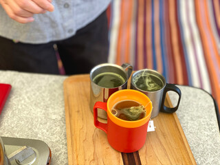 テント内でマグカップにお茶を入れる手