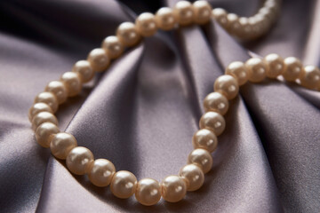 Pearl necklace on black background, close-up