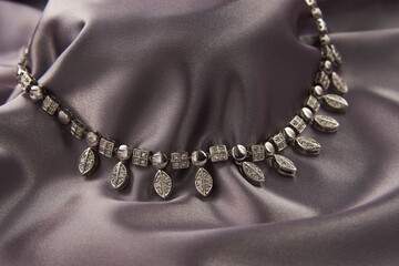 Elegant necklace with diamonds on grey background with copy space