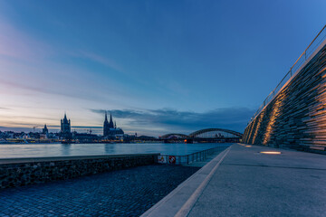 Rhine promenade in Cologne with a view of Cologne Cathedral at the blue hour, Germany.