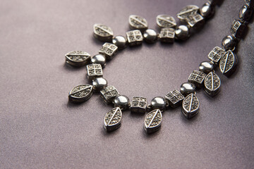 Elegant necklace with diamonds on grey background with copy space