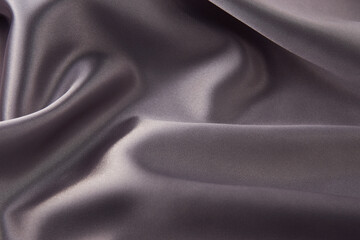 Gray silk fabric background, top view, close-up