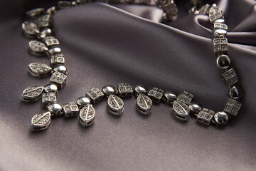 Elegant necklace with diamonds on grey background with copy space