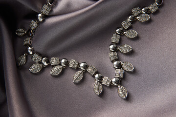 Elegant necklace with diamonds on grey background with copy space