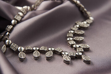 Elegant necklace with diamonds on grey background with copy space