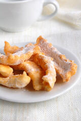 Sweet crunchy stick with sugar powder on the white plate
