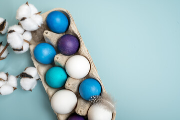 Multi-colored Easter eggs in an egg tray