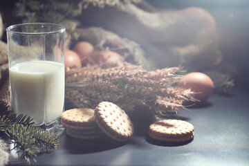 Fresh crunchy cookie with wheat and gluten on a black table. Bakery and grocery concept. Fresh, healthy sorts of rye and white cookies on sackcloth with milk. Homemade cookie with cereals.