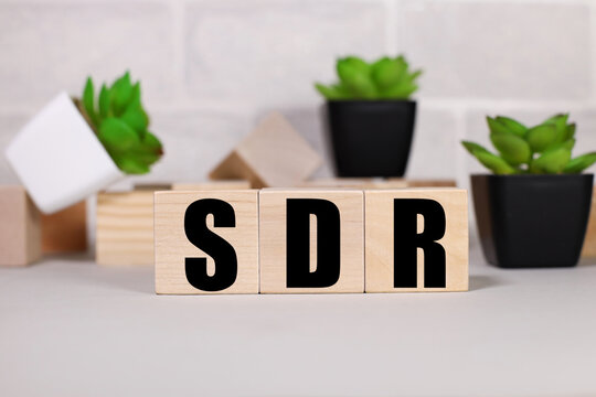 SDR .Special Drawing Rights. adjective. text on wood cubes. text in black letters on wood blocks