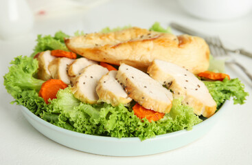 Tasty cooked chicken fillet with fresh salad served on white table. Healthy meals from air fryer