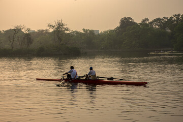 20th MaTwo old men rowers resting while rowing in the morning at Rabindra Sarobar lake, Kolkata....