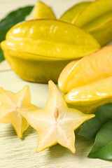 Delicious carambola fruits on yellow wooden table