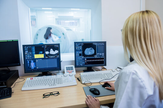 Radiologist in the control room of computed tomography at hospital