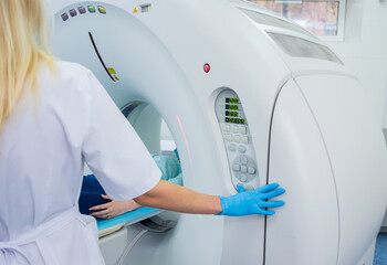 Radiologist with a female patient in the room of computed tomography